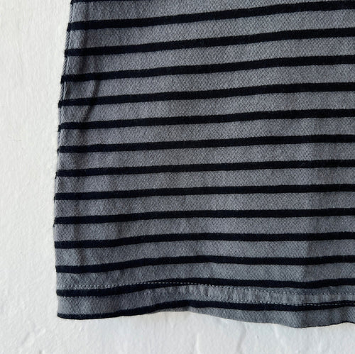 Close-up of gray t-shirt with black stripes on a white backgrond