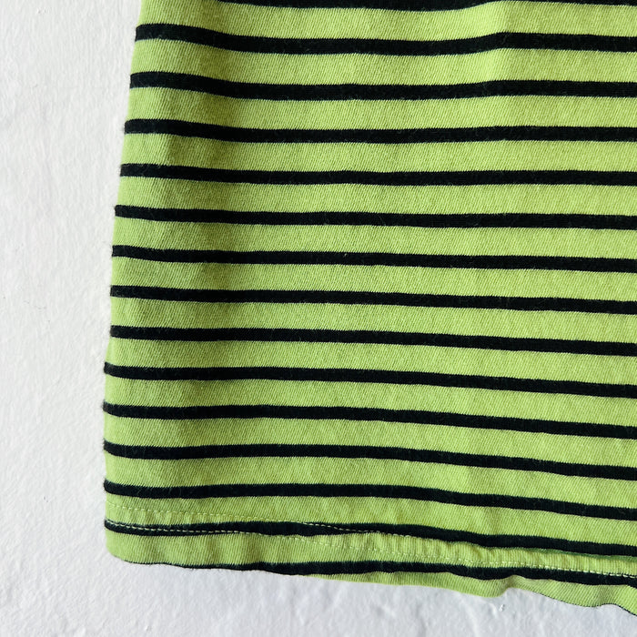 Close-up of green fabric with black stripes on a white background