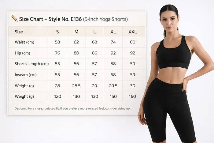 Woman wearing black athletic shorts with a size chart on a white background