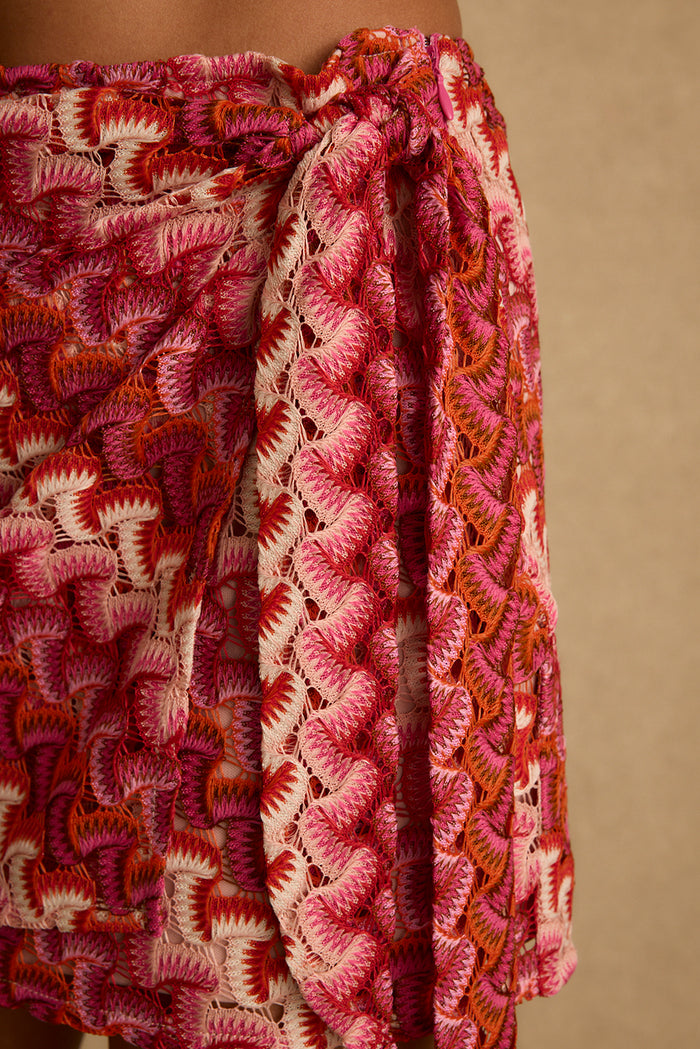 Close-up of pink and orange crochet knit texture on the Amaya wrap mini skirt.