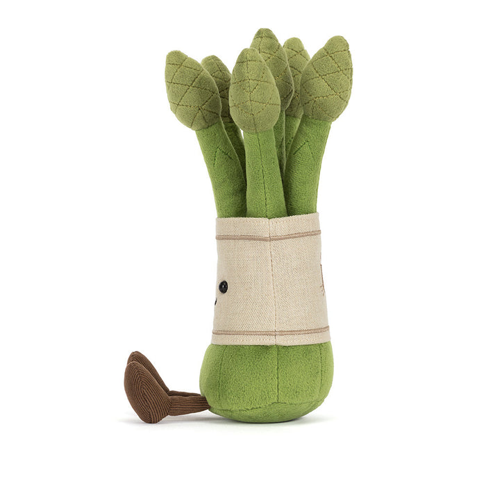 Side profile of Jellycat Amuseables Asparagus showing the full height of the green stalks, cream linen band, one visible black bead eye, and a brown corduroy foot, on a white background
