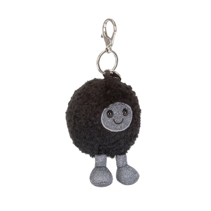 Black plush ball resembling a solar black hole keychain with a smiling face on a white background
