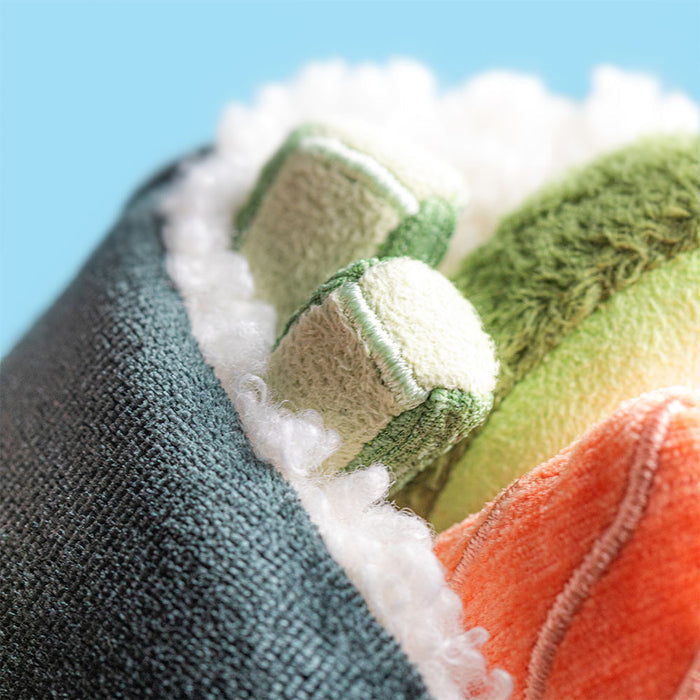 Close-up detail of the Jellycat Amuseables Coneroi Temaki showing textured fabric filling pieces including green avocado, white rice, and orange salmon against a light blue background