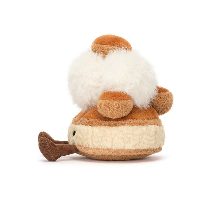Plush toy resembling a pastry with a white beard on a white background, viewed from the side
