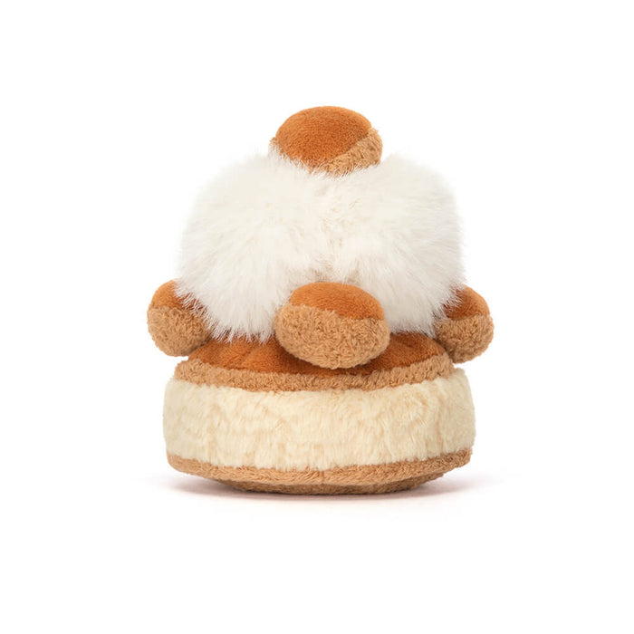 Small plush pastry on a white background, viewed from the back