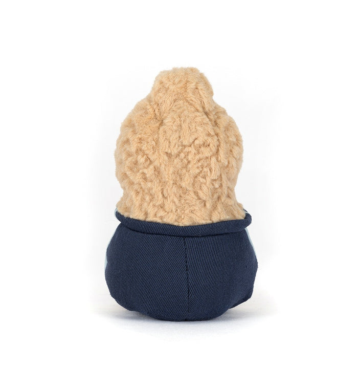 Small plush toy with a beige top and navy bottom on a white background, viewed from the back