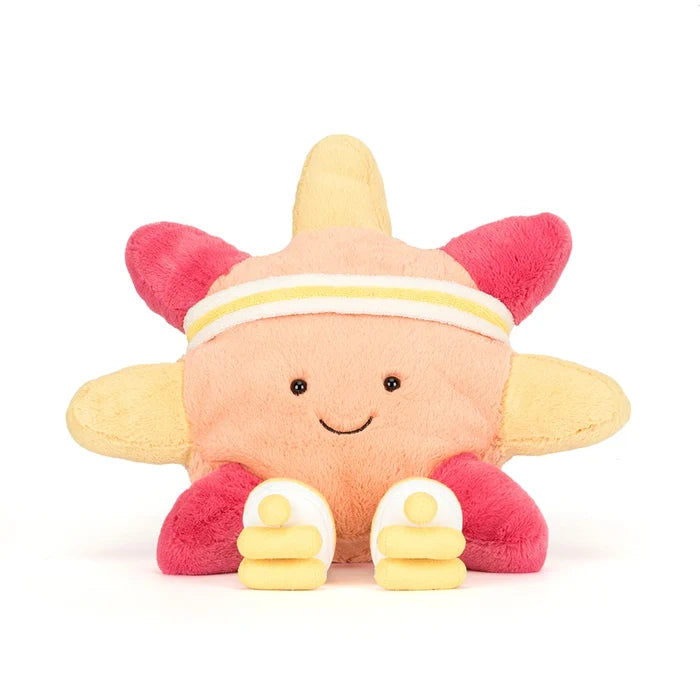 Plush toy resembling a sun with a smiley face on a white background
