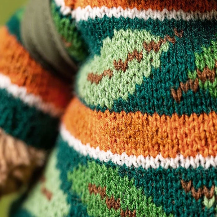 Close-up of a knitted sweater with colorful patterns and text.