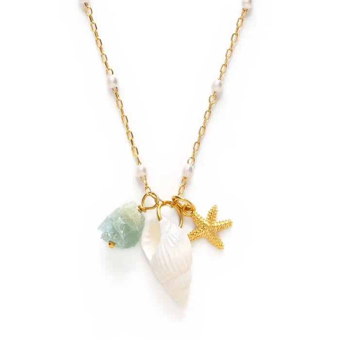 Necklace with starfish, shell, and green stone charm on a white background