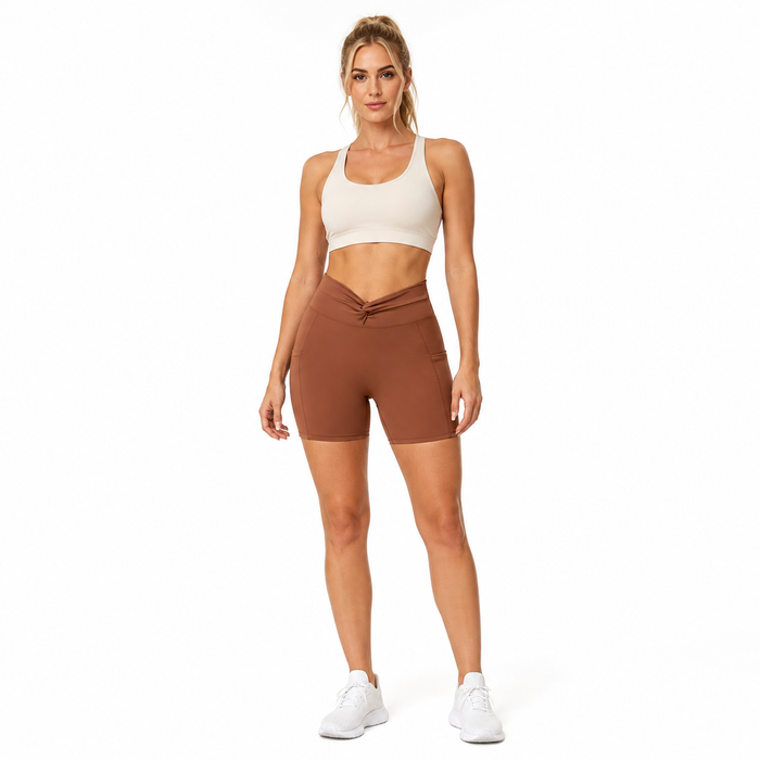 Sugar Brown women's bike shorts with twist-front waistband and side pockets, front studio view