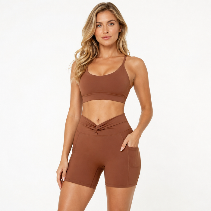 Sugar Brown women's bike shorts in a polished hero pose with twist-front waistband and side pocket