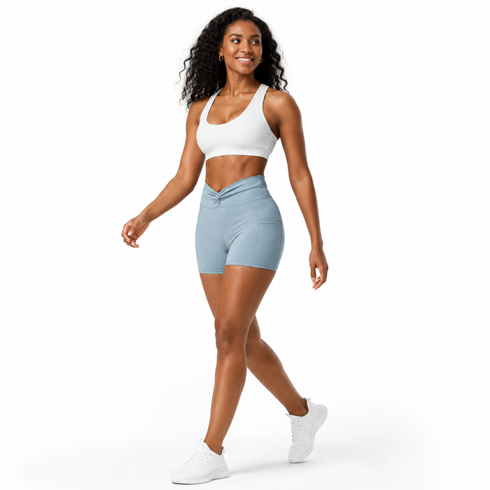 Haze Blue women's bike shorts in a natural walking pose on a clean white studio background