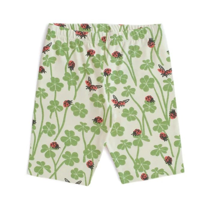 Shorts with a pattern of ladybugs and clover leaves on a white background