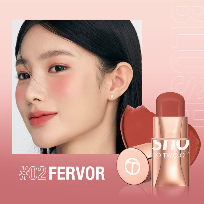 Blush stick shown in a cream makeup format for adding cheek color, with a compact applicator for storage in a makeup bag.