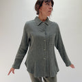 Front three-quarter view of model wearing Mill Valley Clothing Co olive boyfriend button-down shirt, showing point collar, chest pocket, and relaxed oversized fit
