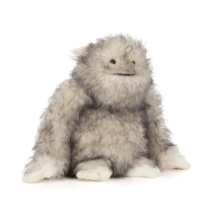 Plush toy resembling a yeti creature with gray and white fur on a white background