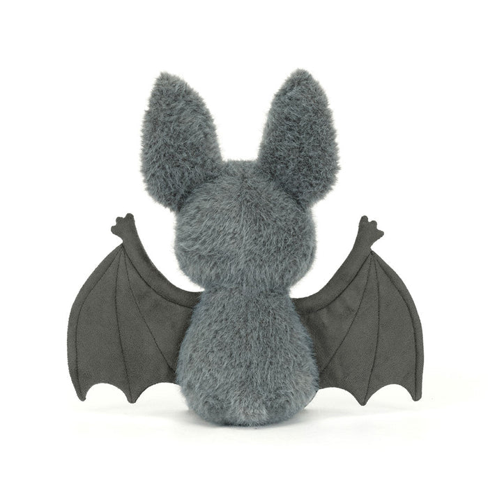 Rear view of the Jellycat Broox Bat plush toy on a white background, showing the blue-grey fluffy back, two large ears, and both dark wings spread wide