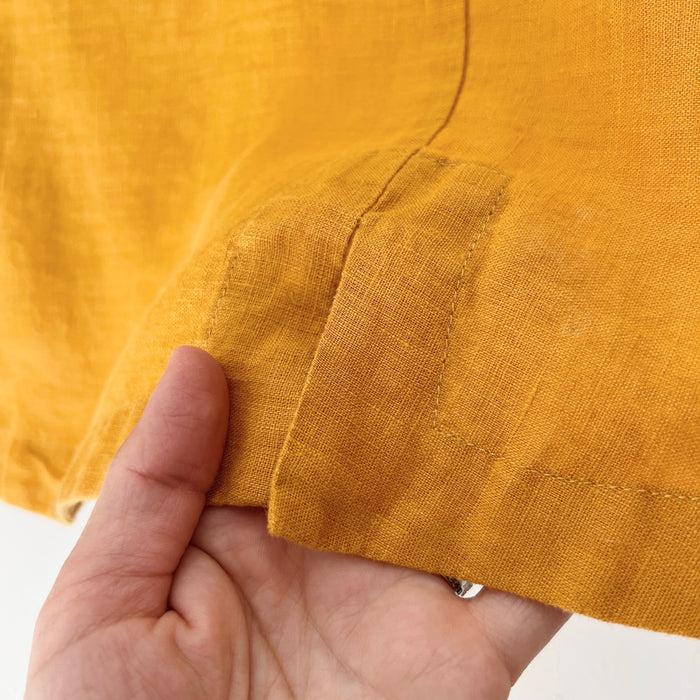 Close-up of a hand holding yellow fabric