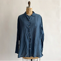 Blue shirt on a mannequin against a plain background
