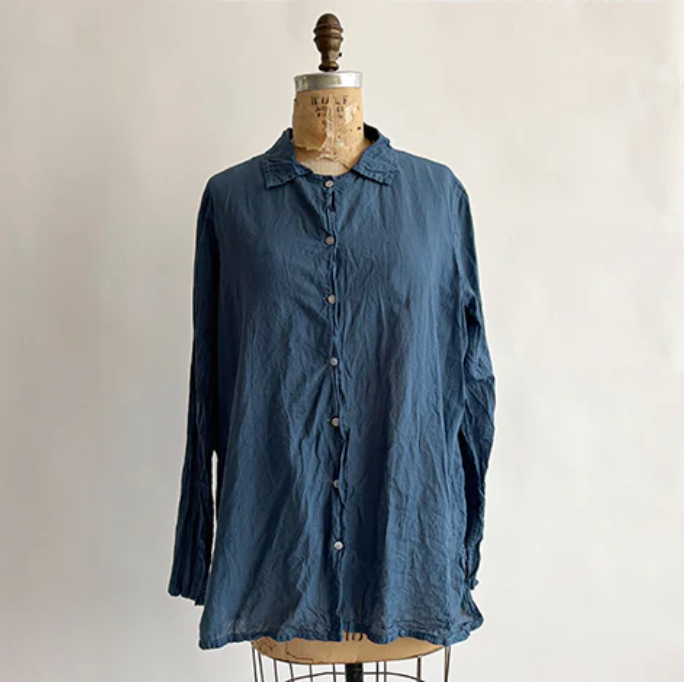 Blue shirt on a mannequin against a plain background