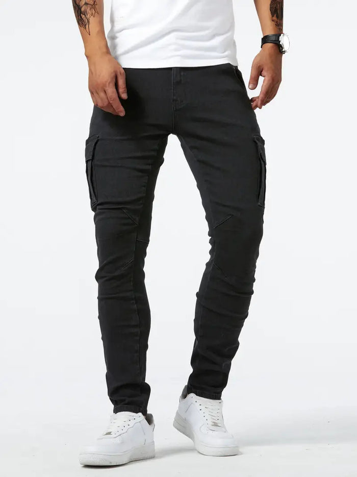 Jet Black cotton denim cargo pants shown close up with zip fly, utility pocket and a slim leg shape for a clear product view.