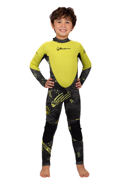Smiling child wearing the Waihana Children's Lime Fishbone Steamer wetsuit in bright lime green and dark grey fishbone-patterned neoprene, standing confidently with hands on hips against a white studio background.