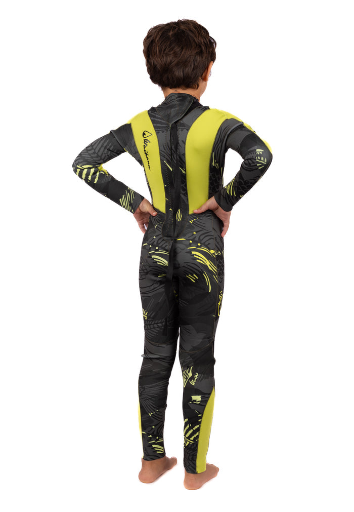 Child model wearing the Waihana Children's Lime Fishbone Steamer full-length wetsuit in dark grey and lime yellow fishbone pattern, photographed from behind showing the back zip and panel detailing.