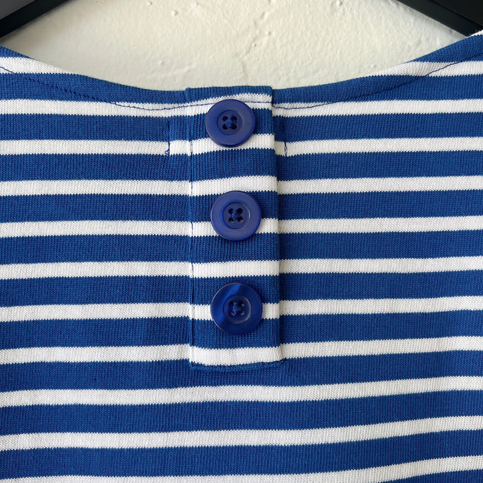 Close-up of a blue and white striped garment with buttons.