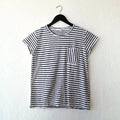 Navy and white striped t-shirt on a hanger against a white wall