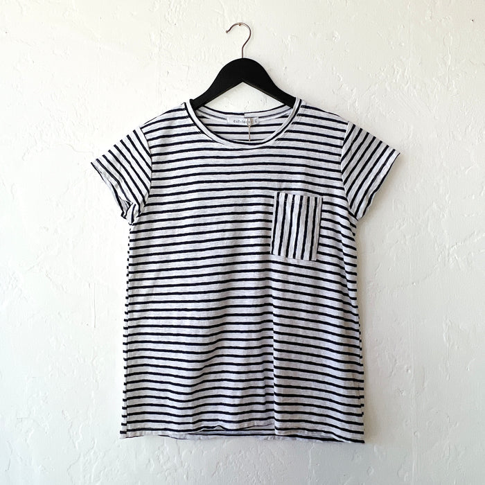 Navy and white striped t-shirt on a hanger against a white wall