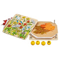 Goki Flower Press open and disassembled on a white background, showing the illustrated wooden top plate with a wildflower meadow design, the hexagonal wooden base plate loaded with autumn leaves and paper inserts, and four yellow wooden screw knobs