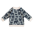 A long-sleeve baby sweatshirt featuring an all-over navy blue elephant pattern on a light sage green background, finished with solid cream ribbed cuffs, collar, and hem.