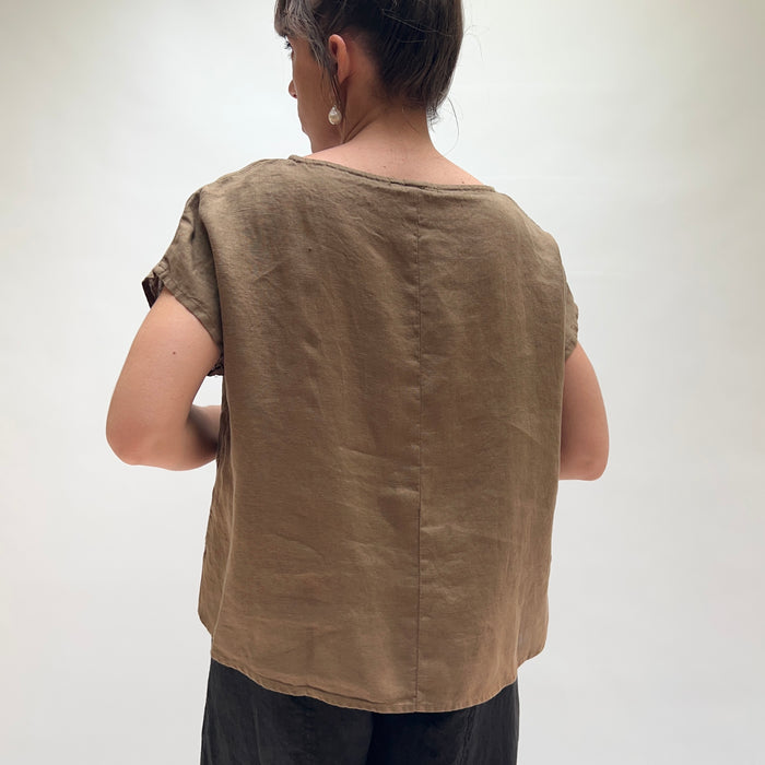 Person wearing a brown sleeveless top against a white background, viewed from the back