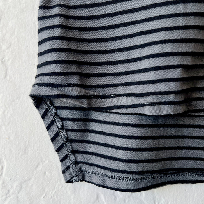 Close-up of a gray and black striped fabric on a textured white background
