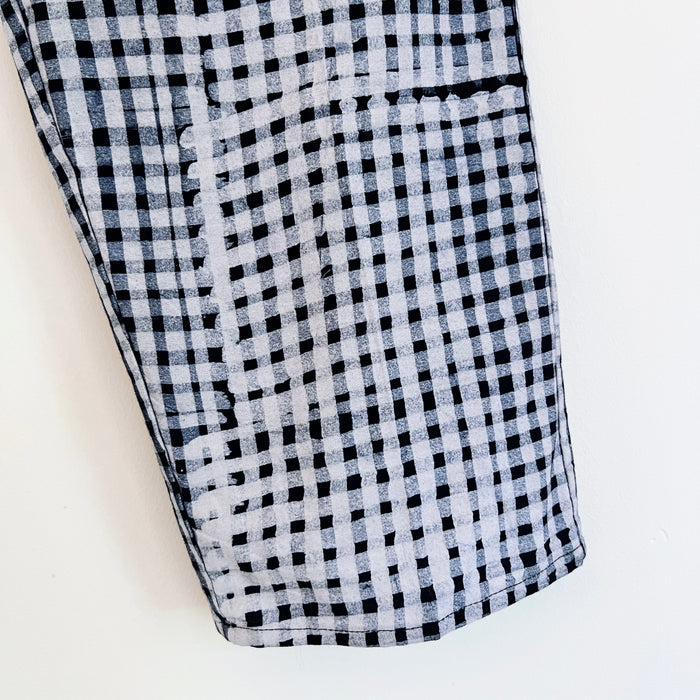 Close-up of the lower leg and hem of the Lazy Pants in Indigo Gingham, showing the hand-printed black and white gingham pattern on 100% cotton Batiki fabric with visible hand-dye texture and hemline detail