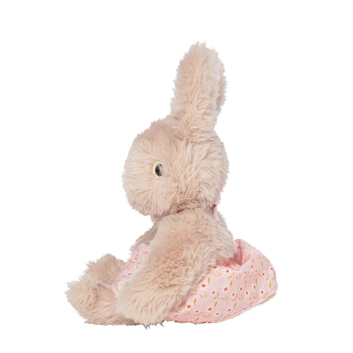 A rabbit stuffed toy in a pink floral apron, shown from the side