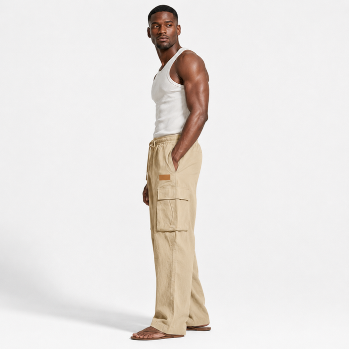 Men's cotton linen pants in khaki shown in a clear side view on an adult male model for an easy look at the silhouette.