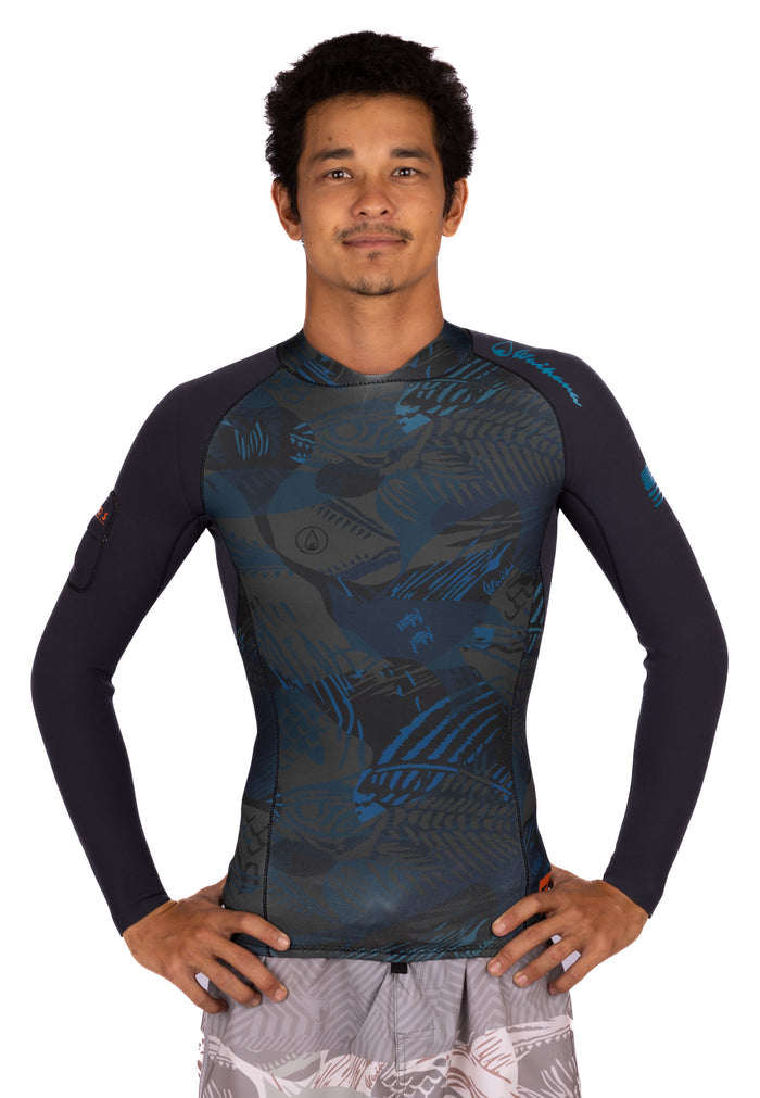 Male model wearing the Waihana Men's Field Ethos Rear-zip Surf Rashguard in FE Blue, featuring a bold graphic ocean-themed print on the chest and dark navy neoprene sleeves.