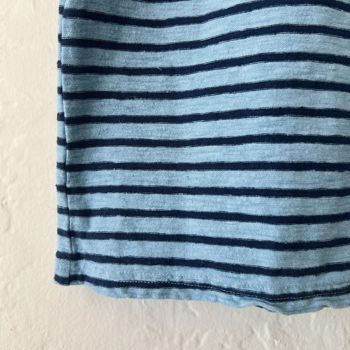 Close-up of a blue and navy striped fabric on a beige background