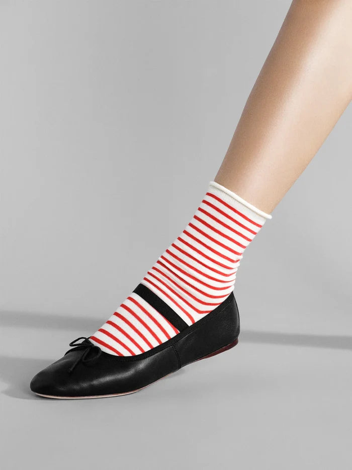 Nautical Stripe Crew socks in Pink — red and cream horizontal stripe crew with rolled cuff, worn with black bow ballet flats on a grey background