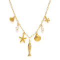 Gold necklace with starfish, shell, and fish charms on a white background