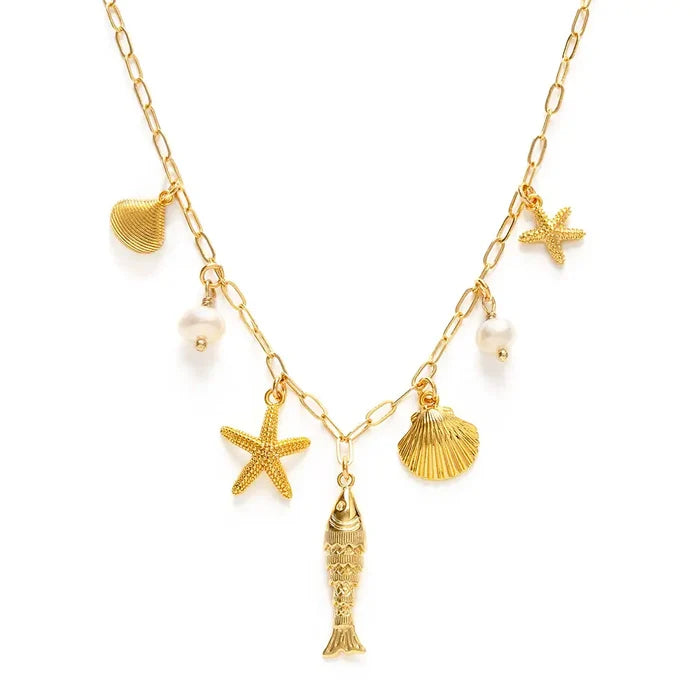 Gold necklace with starfish, shell, and fish charms on a white background