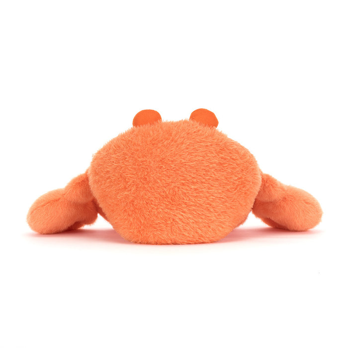 Orange plush crab toy on a white background as seen from behind