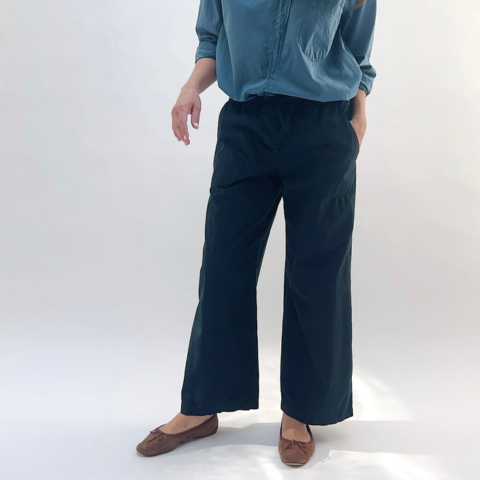 Poplin Sailor Pant in Ink — front three-quarter view with hand in pocket, highlighting wide-leg fit and drawstring waistband