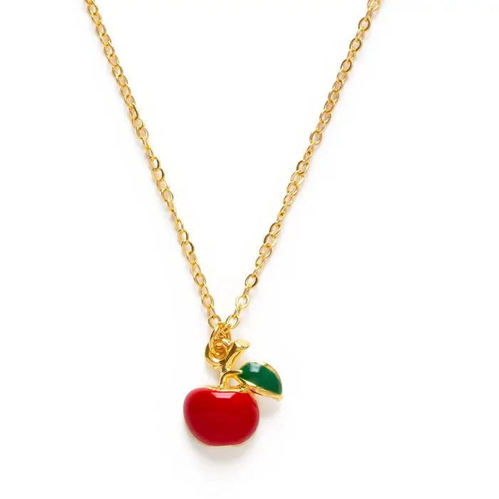 Necklace with a red apple pendant on a gold chain against a white background
