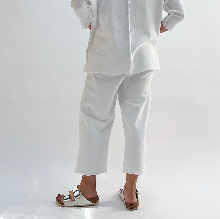 Rib Crop Pant in Chalk, back view showing raw hem and relaxed wide-leg fit, styled with white sandals