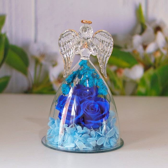 Decorative rose display inside an angel-shaped glass design, showing the outline, base and visible floral arrangement clearly