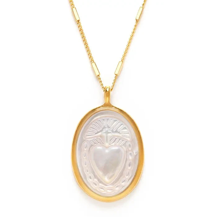 Gold necklace with a heart-shaped pendant on a white background