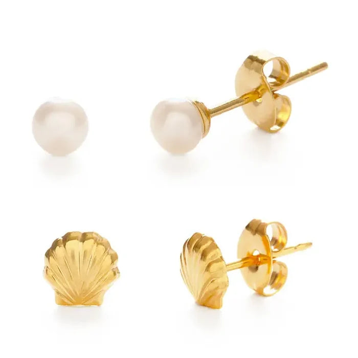 Pair of gold shell earrings and pearl stud earrings on a white background