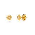 Gold sun-shaped earrings with a central pearl on a white background
